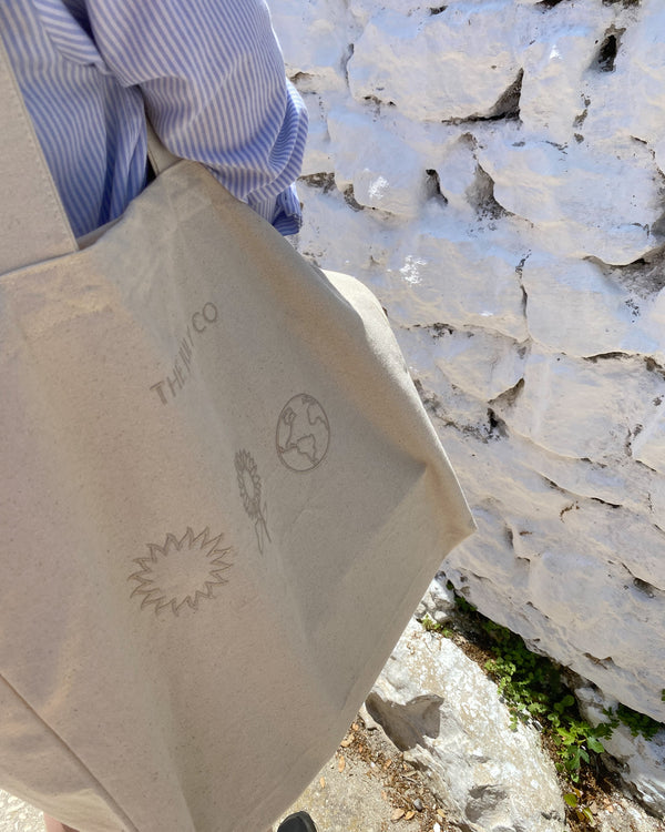 The Earth Tote Bag by The July Co made from 100% heavy weight Fairtrade organic cotton, with side panels for extra space and wide straps for durability. Three symbols embroidery design on front. Perfect beach bag or for travel and weekend breaks.