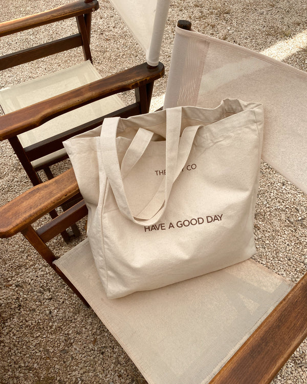 Good Day Tote Bag by The July Co made from 100% heavy weight Fairtrade organic cotton, with side panels for extra space and wide straps for durability. 'Have a Good day' embroidery design on front. Perfect beach bag or for travel and weekend breaks.