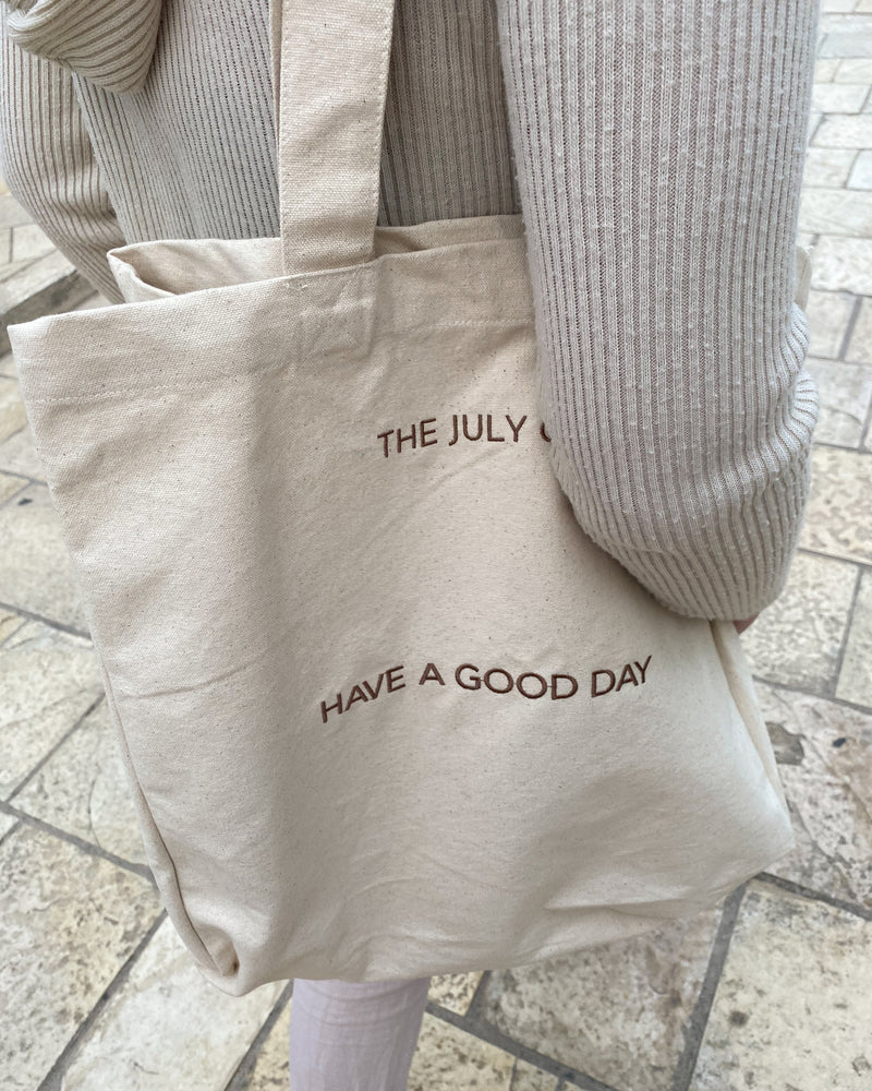 Good Day Tote Bag by The July Co made from 100% heavy weight Fairtrade organic cotton, with side panels for extra space and wide straps for durability. 'Have a Good day' embroidery design on front. Perfect beach bag or for travel and weekend breaks.