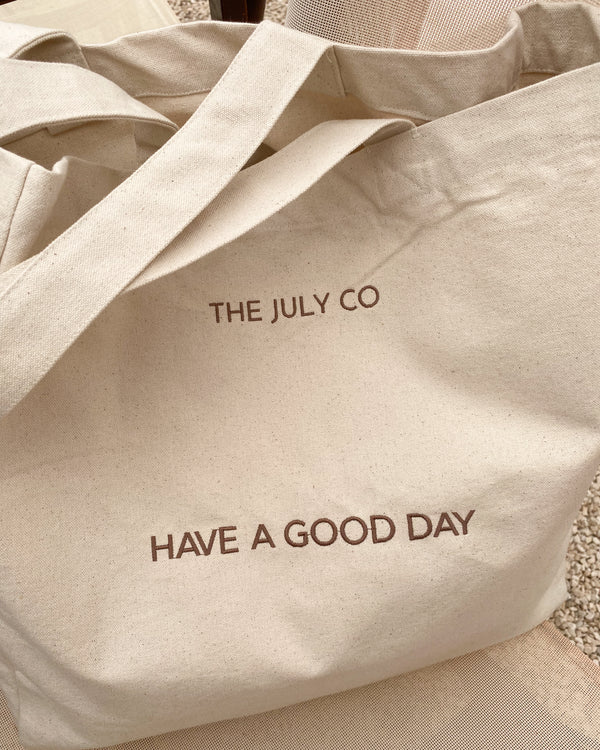 Good Day Tote Bag by The July Co made from 100% heavy weight Fairtrade organic cotton, with side panels for extra space and wide straps for durability. 'Have a Good day' embroidery design on front. Perfect beach bag or for travel and weekend breaks.